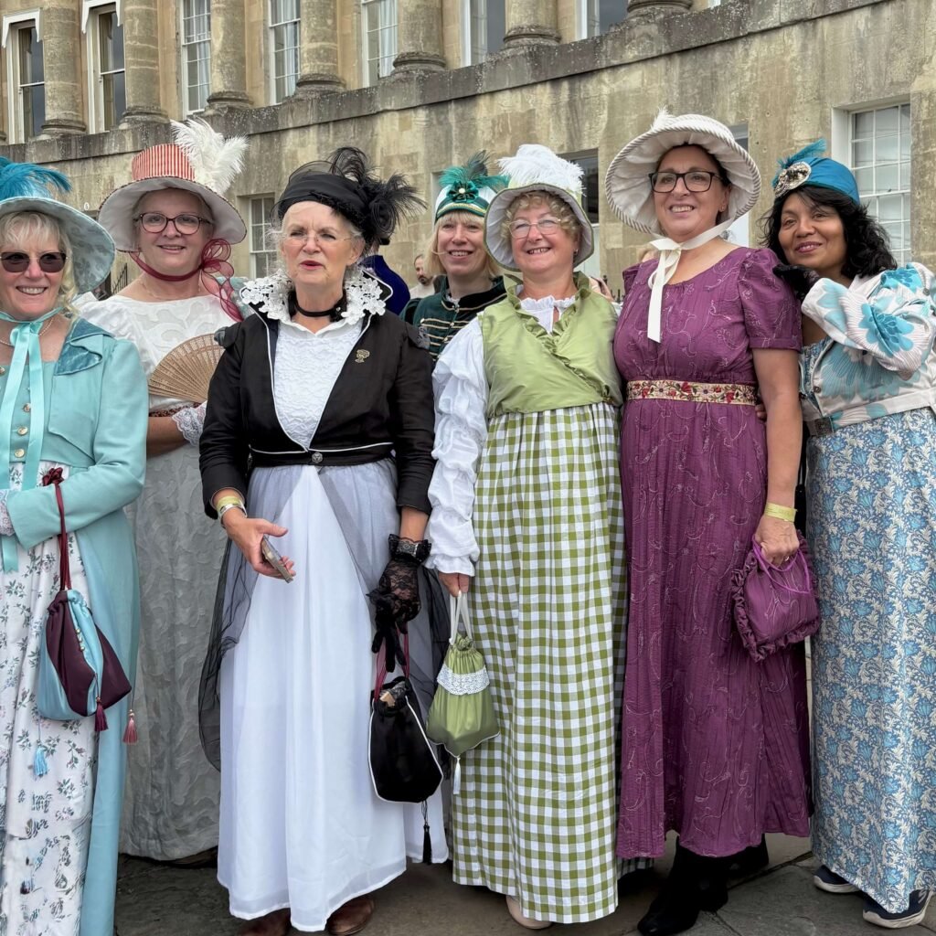 Group of friends in Regency costumes meeting near the Royal Crescent in Bath