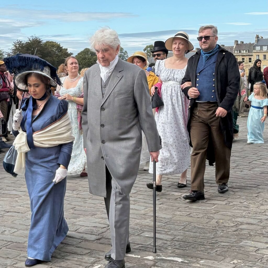 Regency-dressed participants walking together at the Jane Austen Festival in Bath