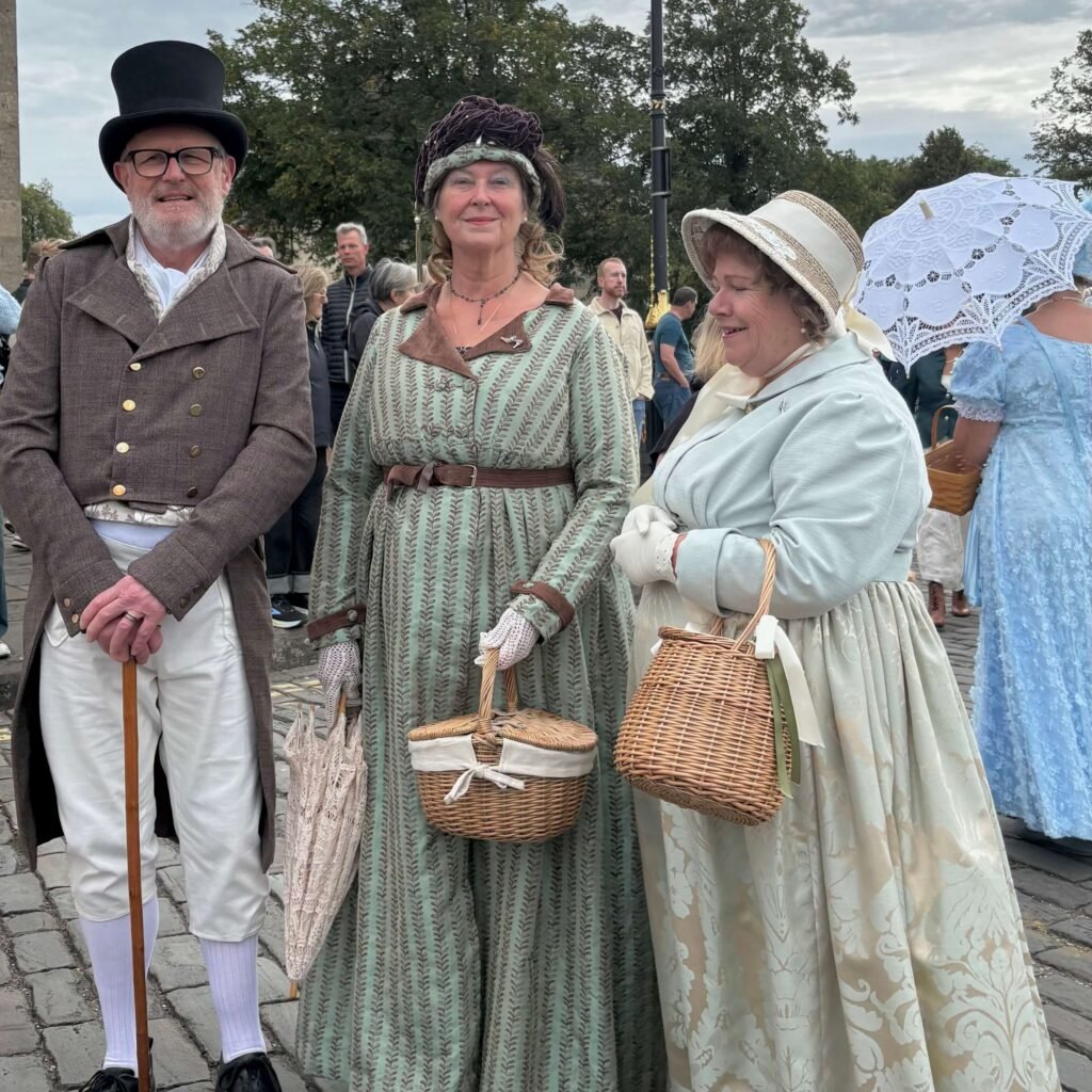 Small group in Regency outfits gathering near the Royal Crescent in Bath